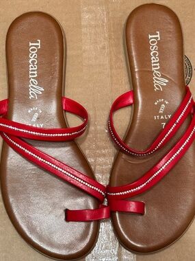 Toscanella brand sandals are red flat thong sandals featuring rhinestone-embelli